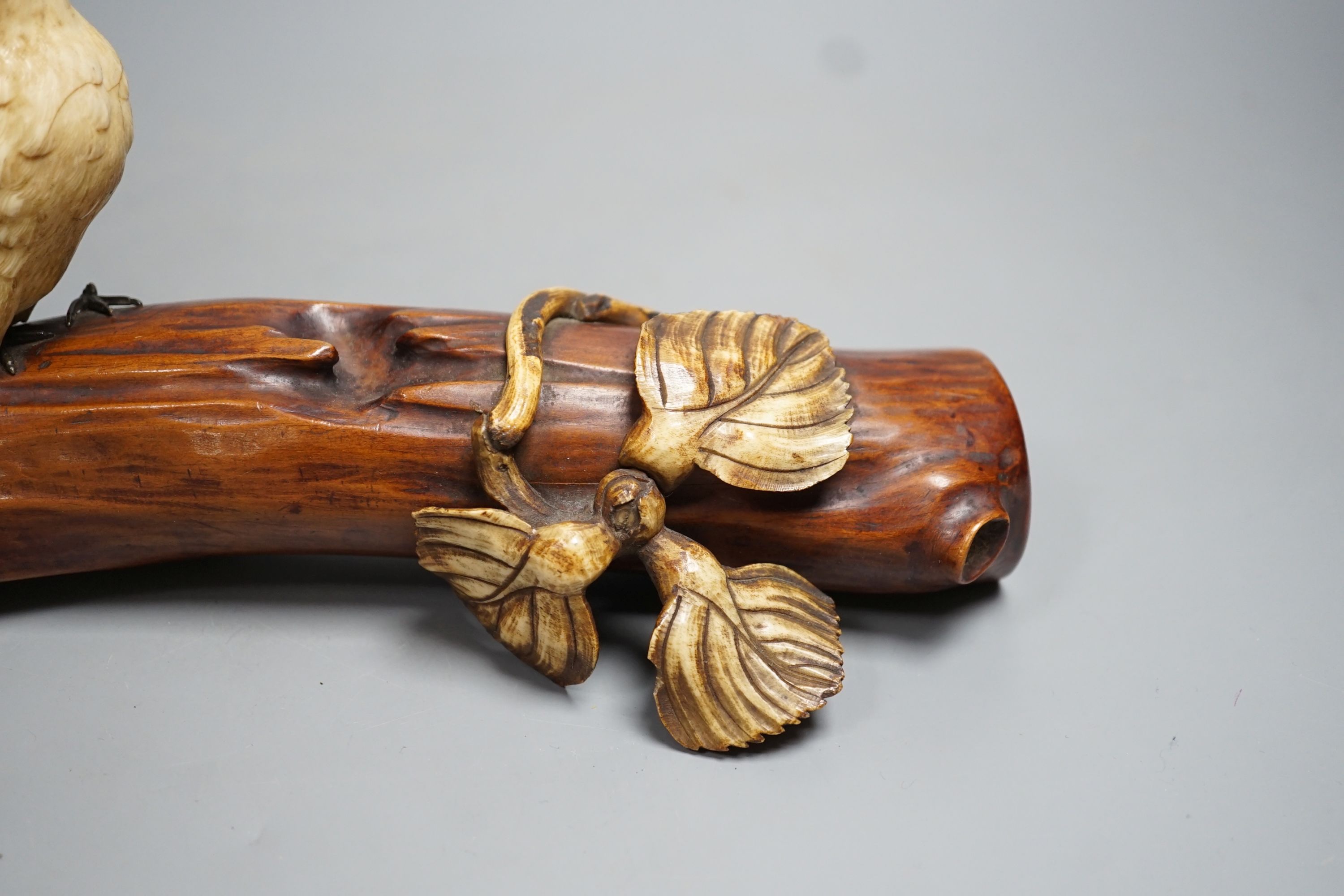 A 19th century Japanese ivory okimono of a kingfisher and log, mother of pearl inset eyes, signed to underside (a.f) 25cm long